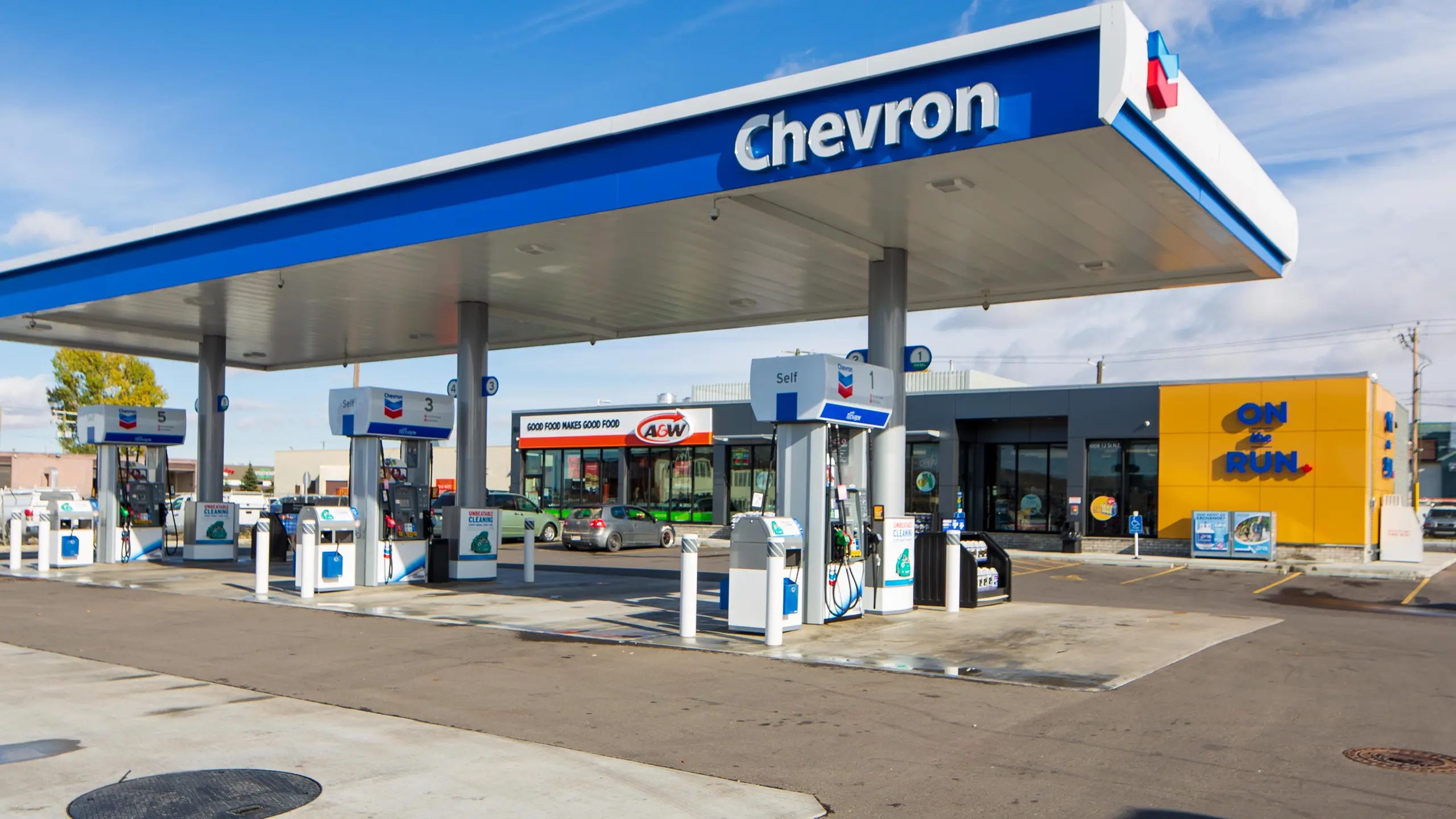 Chevron gas station signage with pylon and canopy branding