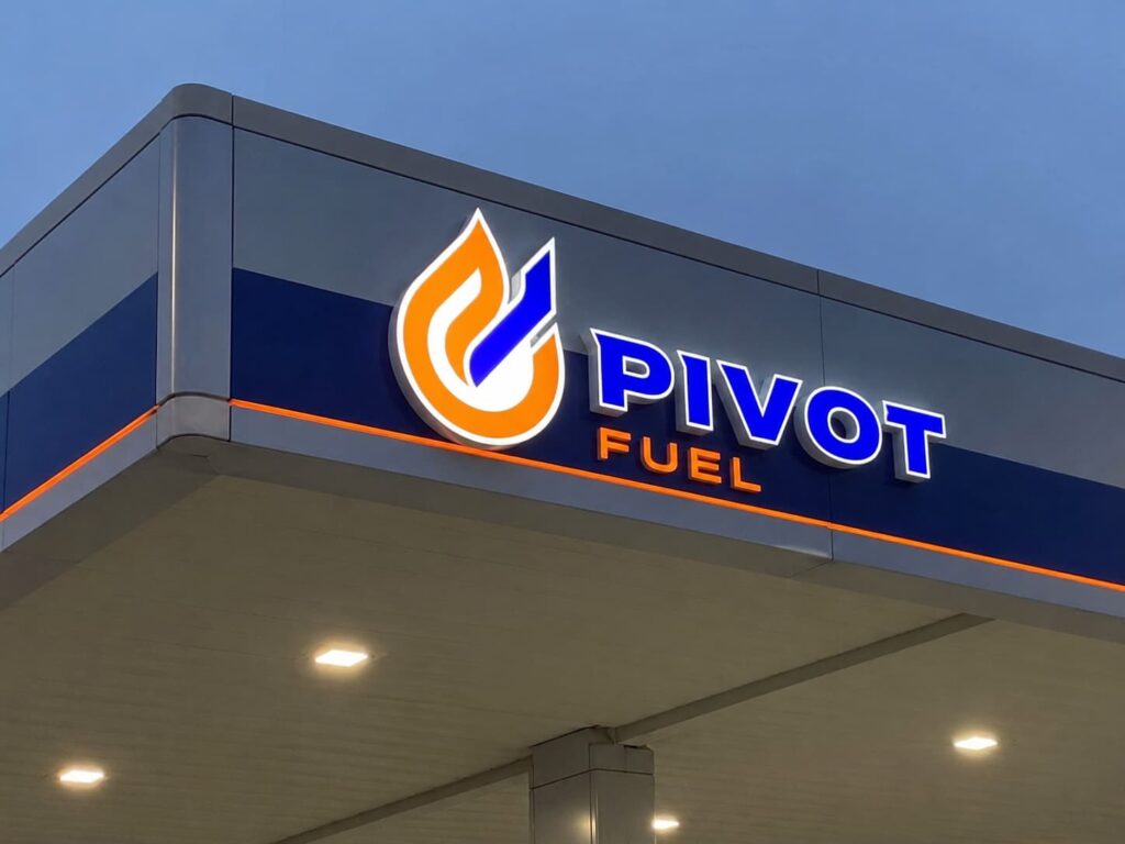custom gas station logo sign on illuminated canopy fascia