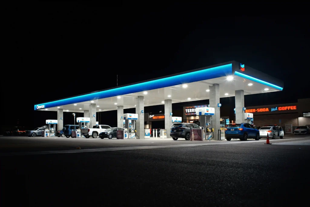 Branded gas station canopy fascia with illuminated logo