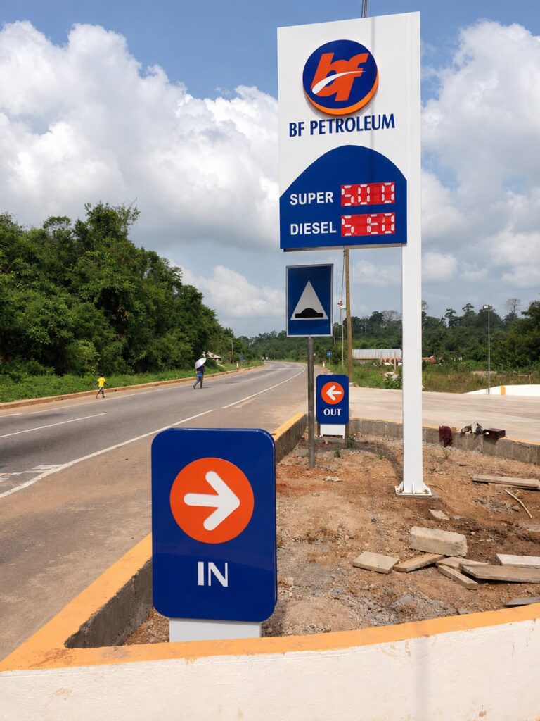 BF Petroleum gas station pylon sign with LED fuel price display and directional signs
