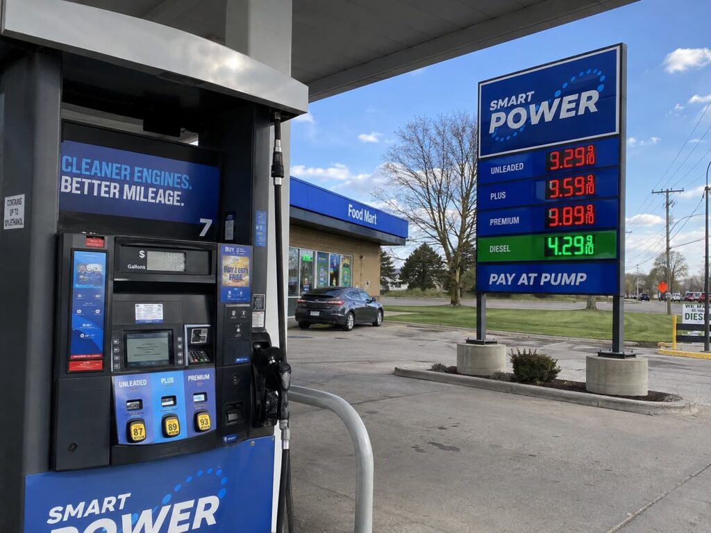 Gas station pump graphics with pylon sign and LED fuel price display