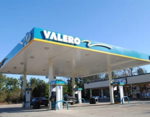 Valero gas canopy with blue fascia panels, branded logo, roof and support columns